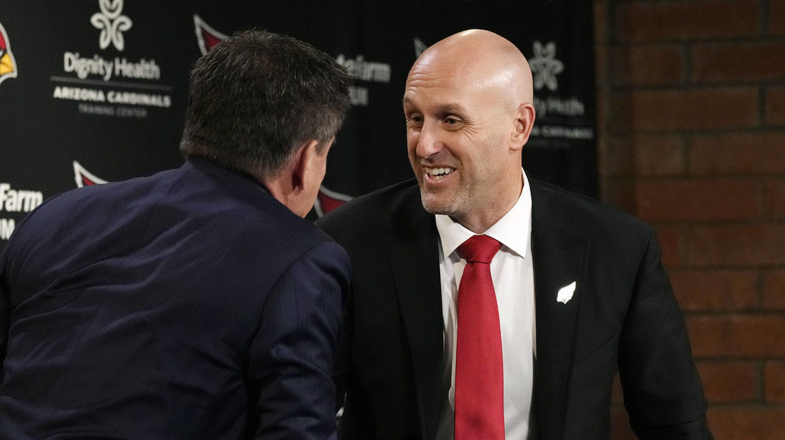 Monti Ossenfort, right, the new general manager of the Arizona Cardinals NFL football team, shakes ...