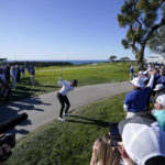 
              Sam Ryder, center, hits alongside the path while playing the 14th hole of the South Course at Torrey Pines during the second round of the Farmers Insurance Open golf tournament, Thursday, Jan. 26, 2023, in San Diego. (AP Photo/Gregory Bull)
            