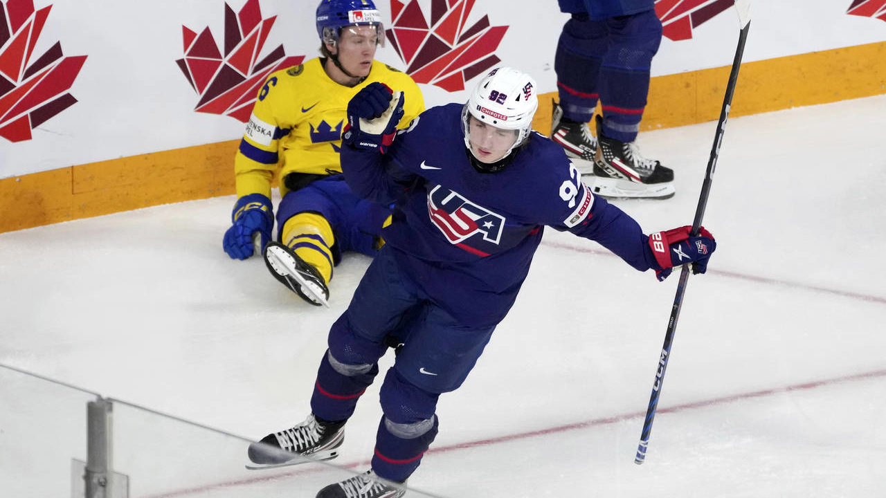 Logan Cooley of the USA celebrates his goal in front of Victor Sjoholm of Sweden during the first p...