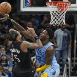 
              Orlando Magic's Paolo Banchero (5) attempts to shoot over Memphis Grizzlies' Jaren Jackson Jr. (13) during the second half of an NBA basketball game, Thursday, Jan. 5, 2023, in Orlando, Fla. (AP Photo/John Raoux)
            