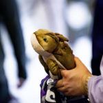 A fan carries a stuffed horned frog as they depart a watch party for the NCAA College Football Playoff national championship game between TCU and Georgia in Fort Worth, Texas, Monday, Jan. 9, 2023. (AP Photo/Emil T. Lippe)