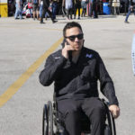 
              Robert Wickens talks on his phone as he makes his way through the garage area at Daytona International Speedway, Thursday, Jan. 26, 2023, in Daytona Beach, Fla. Bryan Herta wants to enter Wickens in the Indianapolis 500 as early as 2024. That's even a year longer than preferred because of the work required on the hand control system needed for the paralyzed driver. (AP Photo/John Raoux)
            