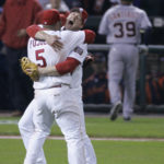 FILE - St. Louis Cardinals Scott Rolen and teammate Albert Pujols celebrate as Detroit Tigers Ramon Santiago walks off the field after the St. Louis Cardinals defeated Detroit Tigers in Game 5 of the World Series in St. Louis,  Oct. 27, 2006. Rolen could become just the 18th third baseman elected to baseball's Hall of Fame, the fewest of any position. Rolen, Todd Helton and Billy Wagner are the leading contenders in the Baseball Writers' Association of America vote announced Tuesday, Jan. 24, 2023.(AP Photo/Tom Gannam, File)