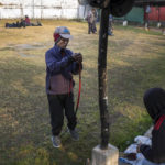 
              A man strings his bow as he prepares to participate in an archery event in Shillong, India, Wednesday, Jan. 18, 2023. Each afternoon, except on Sundays and public holidays, this event takes place in a small field and people place bets on the results. (AP Photo/Ashwini Bhatia)
            