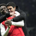 
              Arsenal's Bukayo Saka and Arsenal's manager Mikel Arteta celebrate their victory at the English Premier League soccer match between Tottenham Hotspur and Arsenal at the Tottenham Hotspur Stadium in London, England, Sunday, Jan. 15, 2023. (AP Photo/Frank Augstein)
            