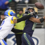 Seattle Seahawks wide receiver Tyler Lockett, right, catches a touchdown in front of Los Angeles Rams cornerback Troy Hill during the second half of an NFL football game Sunday, Jan. 8, 2023, in Seattle. (AP Photo/Stephen Brashear)