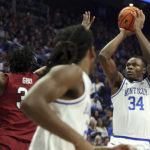 
              Kentucky's Oscar Tshiebwe (34) shoots while defended by South Carolina's Josh Gray, left, during the first half of an NCAA college basketball game in Lexington, Ky., Tuesday, Jan. 10, 2023. (AP Photo/James Crisp)
            