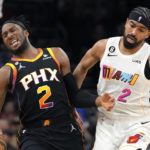 Phoenix Suns forward Josh Okogie (2) is fouled by Miami Heat guard Gabe Vincent during the second half of an NBA basketball game in Phoenix, Friday, Jan. 6, 2023. The Heat won 104-96. (AP Photo/Ross D. Franklin)