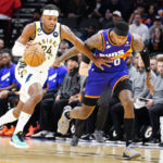 Indiana Pacers' Buddy Field (24) pushes his way past Phoenix Suns' Torrey Craig (0) during the first half of an NBA basketball game in Phoenix, Saturday, Jan. 21, 2023. (AP Photo/Darryl Webb)