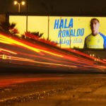 
              In this photo made with a slow shutter speed, a vehicle passes under a billboard showing Cristiano Ronaldo with Arabic wording which reads, Welcome Ronaldo, in Riyadh, Saudi Arabia, late Monday, Jan 2, 2023. Ronaldo completed a lucrative move to Saudi Arabian club Al Nassr on Friday in a deal that is a landmark moment for Middle Eastern soccer but will see one of Europe's biggest stars disappear from the sport's elite stage. (AP Photo/Amr Nabil)
            
