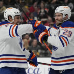 
              Edmonton Oilers center Leon Draisaitl, right, celebrates after scoring against the Vegas Golden Knights during the first period of an NHL hockey game Saturday, Jan. 14, 2023, in Las Vegas. (AP Photo/John Locher)
            