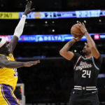 
              Los Angeles Clippers forward Norman Powell, right, shoots as Los Angeles Lakers forward Wenyen Gabriel defends during the first half of an NBA basketball game Tuesday, Jan. 24, 2023, in Los Angeles. (AP Photo/Mark J. Terrill)
            