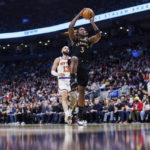 
              Toronto Raptors forward O.G. Anunoby (3) drives to the basket as New York Knicks guard Evan Fournier (13) trails during the first half of an NBA basketball game Friday, Jan. 6, 2023, in Toronto. (Cole Burston/The Canadian Press via AP)
            