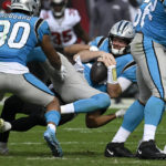 Carolina Panthers quarterback Sam Darnold is sacked by Tampa Bay Buccaneers safety Antoine Winfield Jr. during the first half of an NFL football game between the Carolina Panthers and the Tampa Bay Buccaneers on Sunday, Jan. 1, 2023, in Tampa, Fla. (AP Photo/Jason Behnken)