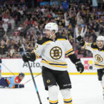 Boston Bruins center Craig Smith (12) and left wing A.J. Greer (10) celebrate after Smith scored during the first period of an NHL hockey game against the Florida Panthers, Saturday, Jan. 28, 2023, in Sunrise, Fla. (AP Photo/Wilfredo Lee)
