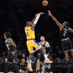 
              Los Angeles Lakers forward LeBron James (6) shoots as Los Angeles Clippers forward Kawhi Leonard (2) defends and guard Terance Mann (14), center Ivica Zubac (40) and center Thomas Bryant watch during the first half of an NBA basketball game Tuesday, Jan. 24, 2023, in Los Angeles. (AP Photo/Mark J. Terrill)
            
