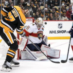 Florida Panthers goaltender Alex Lyon (34) stops a shot by Pittsburgh Penguins' Jeff Carter (77) during the second period of an NHL hockey game in Pittsburgh, Tuesday, Jan. 24, 2023. (AP Photo/Gene J. Puskar)