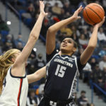 
              Georgetown's Brianna Scott (15) shoots over UConn's Dorka Juhasz in the first half of an NCAA college basketball game, Sunday, Jan. 15, 2023, in Hartford, Conn. (AP Photo/Jessica Hill)
            