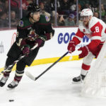 Arizona Coyotes center Nick Schmaltz (8) skates with the puck against Detroit Red Wings center Andrew Copp (18) during the first period of an NHL hockey game in Tempe, Ariz., Tuesday, Jan. 17, 2023. (AP Photo/Ross D. Franklin)
