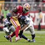 San Francisco 49ers wide receiver Deebo Samuel (19) runs against Seattle Seahawks cornerback Tariq Woolen (27) and safety Quandre Diggs (6) during the second half of an NFL wild card playoff football game in Santa Clara, Calif., Saturday, Jan. 14, 2023. (AP Photo/Godofredo A. Vásquez)