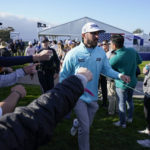 
              Max Homa greets fans on his way to the 14th hole of the South Course at Torrey Pines during the final round of the Farmers Insurance Open golf tournament, Saturday, Jan. 28, 2023, in San Diego. (AP Photo/Gregory Bull)
            