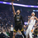 
              Golden State Warriors guard Stephen Curry (30) shoots next to Phoenix Suns' Damion Lee (10) during the first half of an NBA basketball game in San Francisco, Tuesday, Jan. 10, 2023. (AP Photo/Godofredo A. Vásquez)
            