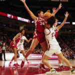 
              South Carolina guard Brea Beal (12) drives into Arkansas guard Chrissy Carr during the first half of an NCAA college basketball game in Columbia, S.C., Sunday, Jan. 22, 2023. (AP Photo/Nell Redmond)
            