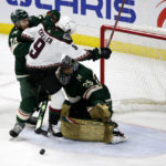 Minnesota Wild goaltender Marc-Andre Fleury (29) blocks a shot as Arizona Coyotes right wing Clayton Keller (9) and Wild defenseman Matt Dumba (24) fight for position in the third period during an NHL hockey game Saturday, Jan. 14, 2023, in St. Paul, Minn. (AP Photo/Andy Clayton-King)