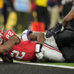 Georgia running back Branson Robinson (22) falls into the end zone against TCU safety Mark Perry (3) during the second half of the national championship NCAA College Football Playoff game, Monday, Jan. 9, 2023, in Inglewood, Calif. (AP Photo/Ashley Landis)