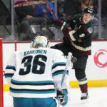 Arizona Coyotes right wing Clayton Keller (9) fires a shot off the stick of San Jose Sharks goaltender Kaapo Kahkonen (36) during the third period of an NHL hockey game in Tempe, Ariz., Tuesday, Jan. 10, 2023. The Sharks won 4-2. (AP Photo/Ross D. Franklin)