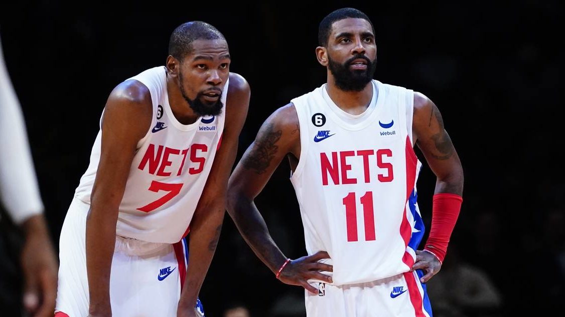 Brooklyn Nets' Kevin Durant (7) talks to Kyrie Irving (11) during the second half of an NBA basketb...