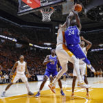 Kentucky forward Chris Livingston (24) has his shot blocked by Tennessee forward Uros Plavsic (33) during the second half of an NCAA college basketball game Saturday, Jan. 14, 2023, in Knoxville, Tenn. (AP Photo/Wade Payne)