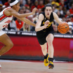 Iowa guard Caitlin Clark, right, dribbles past Ohio State forward Taylor Thierry during the first half of an NCAA college basketball game at Value City Arena in Columbus, Ohio, Monday, Jan. 23, 2023. (AP Photo/Joe Maiorana)