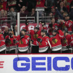 The Chicago Blackhawks celebrate after an empty-net goal by center Tyler Johnson against the Arizona Coyotes during the third period of an NHL hockey game Friday, Jan. 6, 2023, in Chicago. (AP Photo/Erin Hooley)