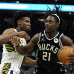 
              Milwaukee Bucks' Jrue Holiday (21) drives to the basket against Indiana Pacers' Aaron Nesmith during the second half of an NBA basketball game Monday, Jan. 16, 2023, in Milwaukee. (AP Photo/Aaron Gash)
            