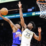 Phoenix Suns' Saben Lee (38) goes to the basket against Indiana Pacers' Aaron Nesmith (23) during the second half of an NBA basketball game in Phoenix, Saturday, Jan. 21, 2023. (AP Photo/Darryl Webb)