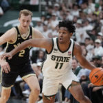 
              Michigan State guard A.J. Hoggard (11) derives past Purdue guard Fletcher Loyer (2) during the second half of an NCAA college basketball game, Monday, Jan. 16, 2023, in East Lansing, Mich. (AP Photo/Carlos Osorio)
            