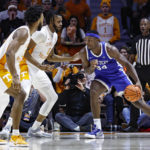 Kentucky forward Oscar Tshiebwe (34) looks for an opening as Tennessee forward Jonas Aidoo (0) and guard Josiah-Jordan James (30) defend during the first half of an NCAA college basketball game Saturday, Jan. 14, 2023, in Knoxville, Tenn. (AP Photo/Wade Payne)
