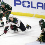 Arizona Coyotes right wing Dylan Guenther (11) shoots on Minnesota Wild goaltender Marc-Andre Fleury (29) as Wild defenseman Jared Spurgeon (46) looks on in the first period during an NHL hockey game Saturday, Jan. 14, 2023, in St. Paul, Minn. (AP Photo/Andy Clayton-King)