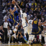 Golden State Warriors guard Jordan Poole, left, shoots over Memphis Grizzlies guard Ziaire Williams (8) during the second half of an NBA basketball game in San Francisco, Wednesday, Jan. 25, 2023. (AP Photo/Godofredo A. Vásquez)