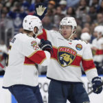 Florida Panthers forward Carter Verhaeghe (23) celebrates a goal against the Toronto Maple Leafs with defenseman Aaron Ekblad (5) during the first period of an NHL hockey game Tuesday, Jan. 17, 2023, in Toronto. (Nathan Denette/The Canadian Press via AP)