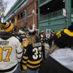 Hockey fans wait for the gates to open prior to the NHL Winter Classic hockey game between the Pittsburgh Penguins and Boston Bruins at Fenway Park, Monday, Jan. 2, 2023, in Boston. (AP Photo/Charles Krupa)