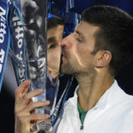 
              FILE - Serbia's Novak Djokovic poses with his trophy after defeating Norway's Casper Ruud in the singles final tennis match to win the ATP World Tour Finals in Turin, Italy, Sunday, Nov. 20, 2022. Djokovic had just wrapped up last season by winning the ATP Finals for a record sixth time when, rather than looking ahead to 2023, his mind immediately went back to the way 2022 began: He was unable to compete in last year's Australian Open after being deported from the country because he was not vaccinated against COVID-19.(AP Photo/Antonio Calanni, File)
            