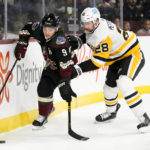 
              Arizona Coyotes right wing Clayton Keller (9) tries to keep the puck away from Pittsburgh Penguins defenseman Marcus Pettersson (28) during the first period of an NHL hockey game in Tempe, Ariz., Sunday, Jan. 8, 2023. (AP Photo/Ross D. Franklin)
            