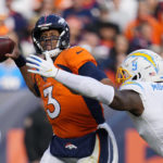 
              Denver Broncos quarterback Russell Wilson (3) is pressured by Los Angeles Chargers linebacker Kenneth Murray Jr. (9) has he throws during the first half of an NFL football game in Denver, Sunday, Jan. 8, 2023. (AP Photo/Jack Dempsey)
            