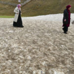 
              Women walk on a patch of melting artificial snow in Vlasic, a ski resort affected by unusual warm weather in Bosnia, Tuesday, Jan. 3, 2023. The exceptional wintertime warmth is affecting ski resorts across Bosnia, prompting tourism authorities in parts of the country to consider declaring a state of natural emergency. (AP Photo/Almir Alic)
            