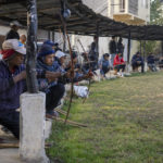 
              Archers shoot at a hay target at an archery event in Shillong, India, Wednesday, Jan. 18, 2023. Each afternoon, except on Sundays and public holidays, this event takes place in a small field and people place bets on the results. (AP Photo/Ashwini Bhatia)
            