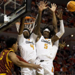 
              Oklahoma State's Woody Newton (4) and Caleb Asberry (5) block Iowa State's Tamin Lipsey (3) shot during the second half of the NCAA college basketball game in Stillwater, Okla., Saturday, Jan. 21, 2023. (AP Photo/Mitch Alcala)
            