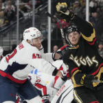 Vegas Golden Knights right wing Jonas Rondbjerg (46) knocks the puck out of the air against Washington Capitals defenseman Martin Fehervary (42) during the second period of an NHL hockey game Saturday, Jan. 21, 2023, in Las Vegas. (AP Photo/John Locher)