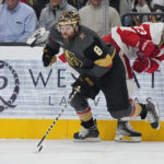 Vegas Golden Knights right wing Phil Kessel (8) vies for the puck with Detroit Red Wings left wing Lucas Raymond (23) during the first period of an NHL hockey game Thursday, Jan. 19, 2023, in Las Vegas. (AP Photo/John Locher)